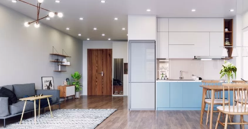 Snímek moderního družstevní bytu s novou kuchyňskou linkou, jídelním stolem a obývacím koutem s pohovkou.